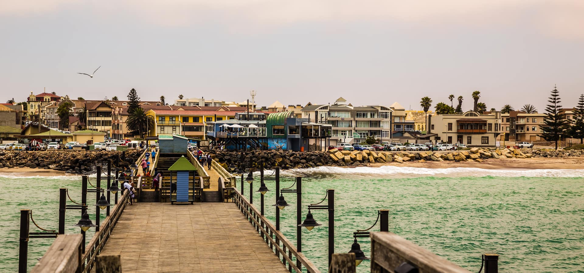 People walking the Swakopmund pier along the coastline