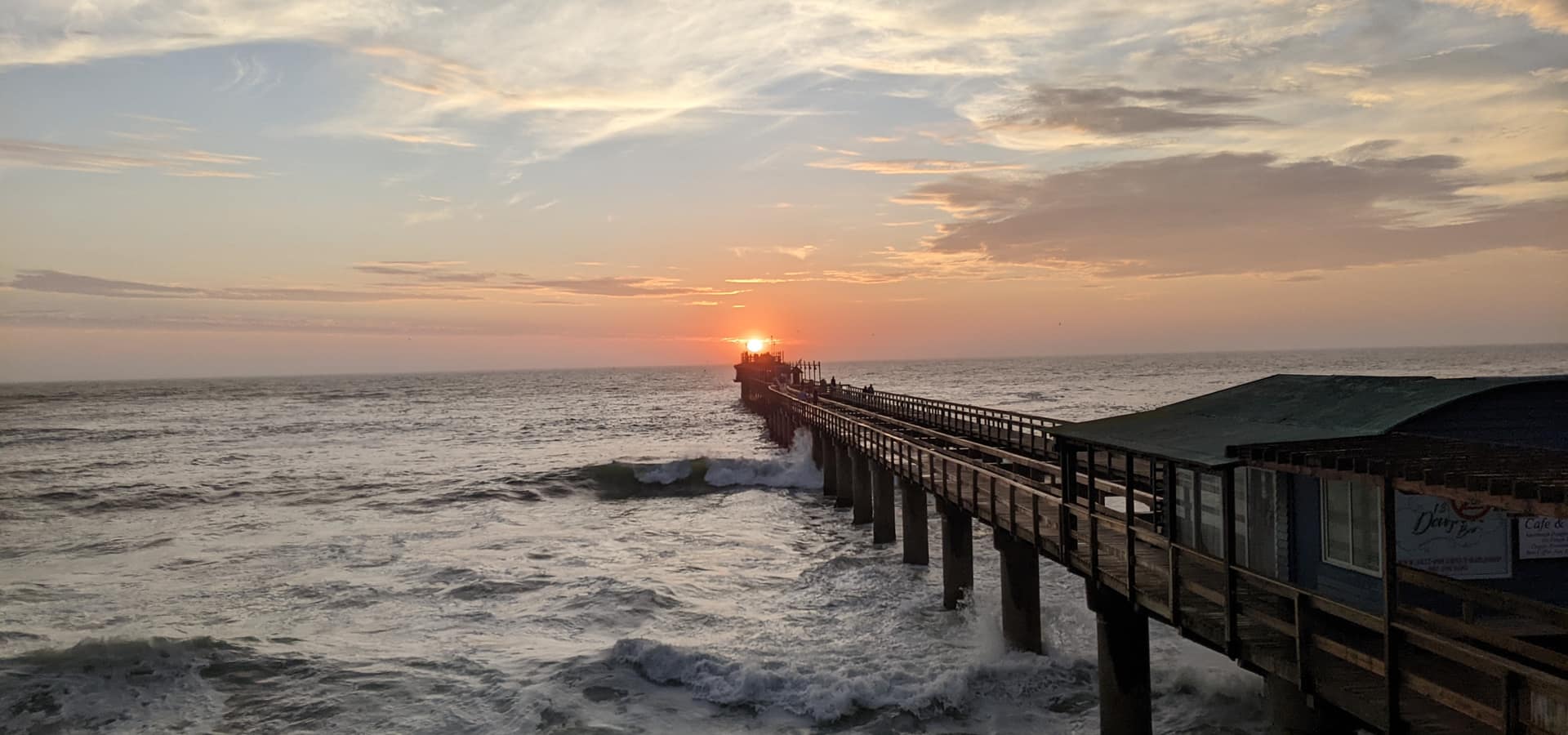 Sunset over the Swakopmund jetty and café