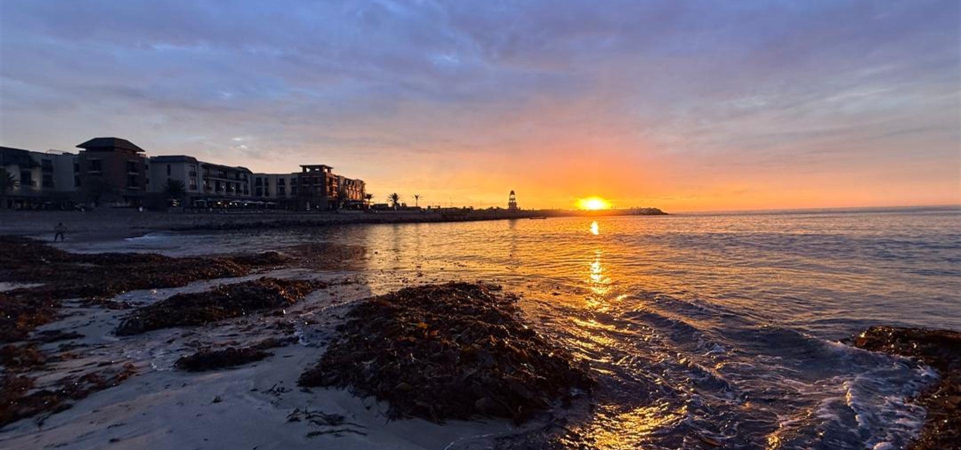 Sunset over the Mole and lighthouse from the Swakopmund beach